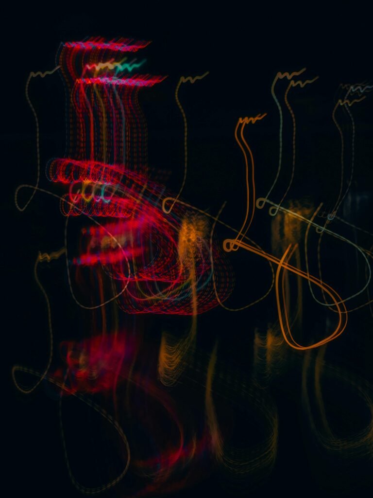 Colorful abstract light trails creating a dynamic pattern on a black background.